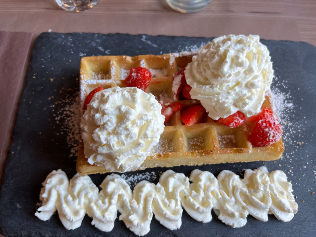 Belgian waffle with strawberries and cream